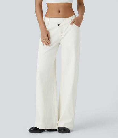 Jeans anchos de cintura baja, bolsillos con cremallera asimétricos, acabado lavado