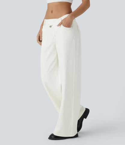 Jeans anchos de cintura baja, bolsillos con cremallera asimétricos, acabado lavado