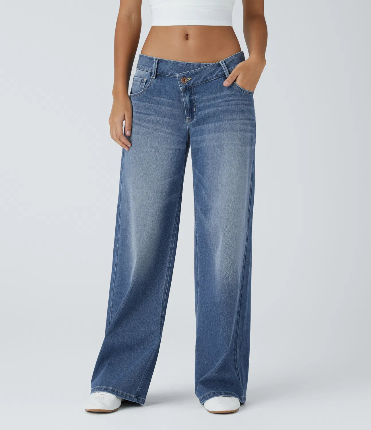 Jeans anchos de cintura baja, bolsillos con cremallera asimétricos, acabado lavado