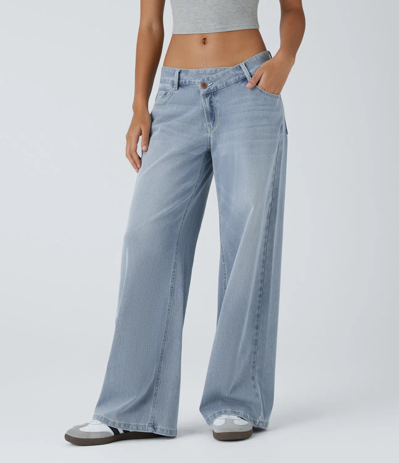 Jeans anchos de cintura baja, bolsillos con cremallera asimétricos, acabado lavado
